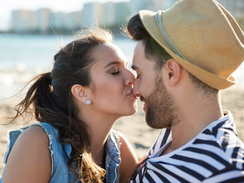 Young woman kissing her boyfriend on the nose